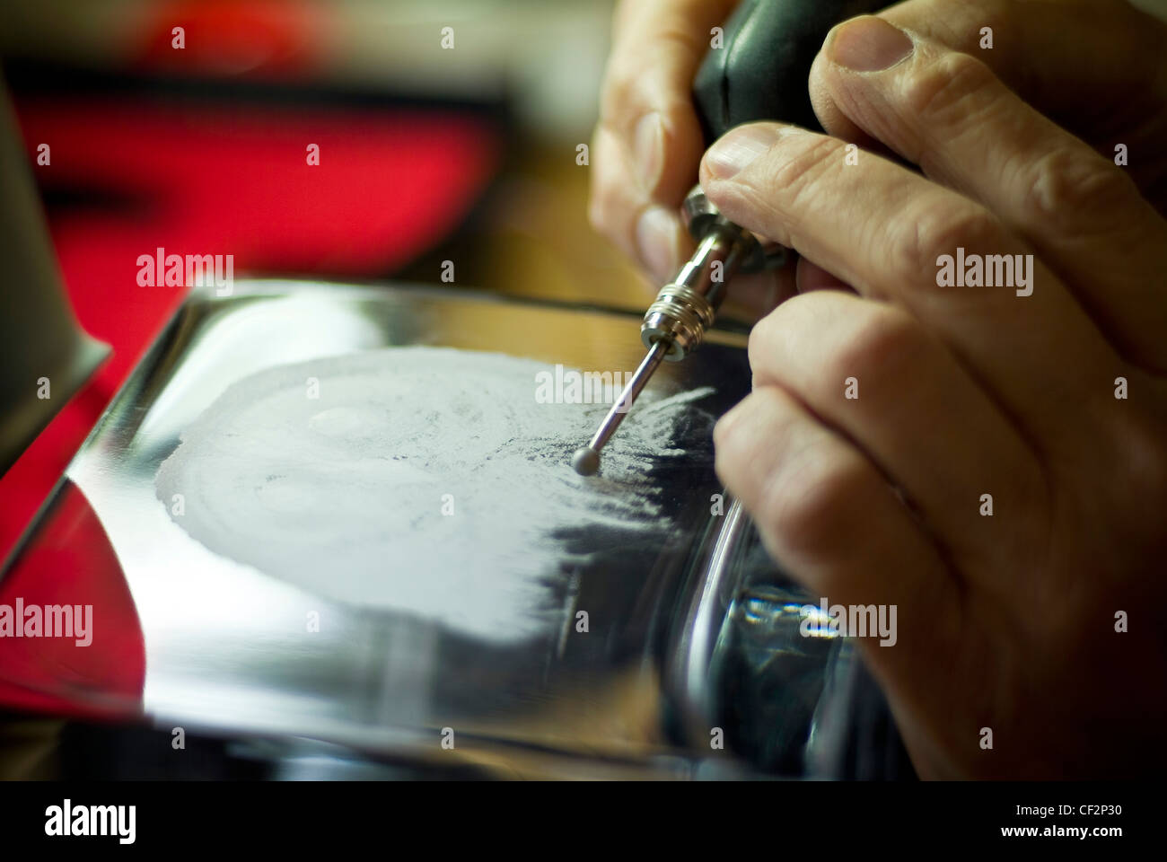 Engraver using a precision electric glass engraving tool Stock Photo - Alamy