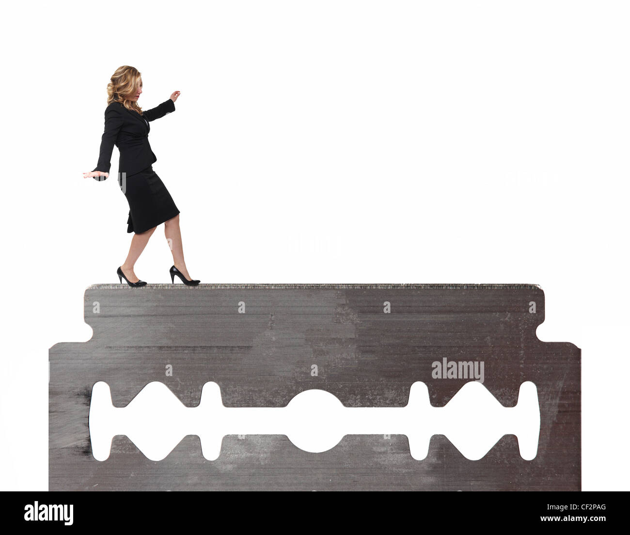 businesswoman walk on razor blade Stock Photo