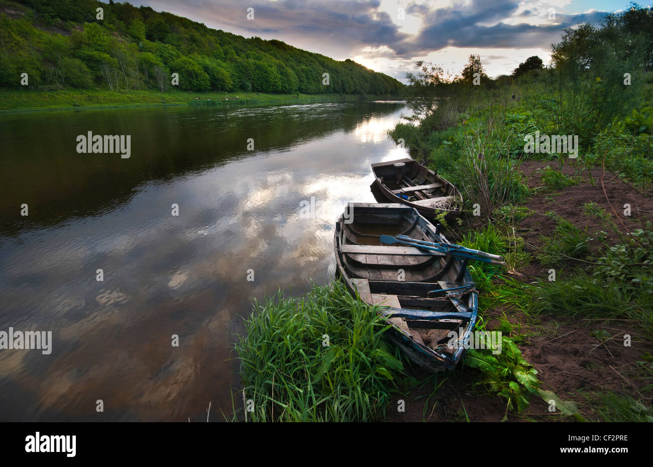 Old fishing boats on the riverbank of the River Tweed. Stock Photo
