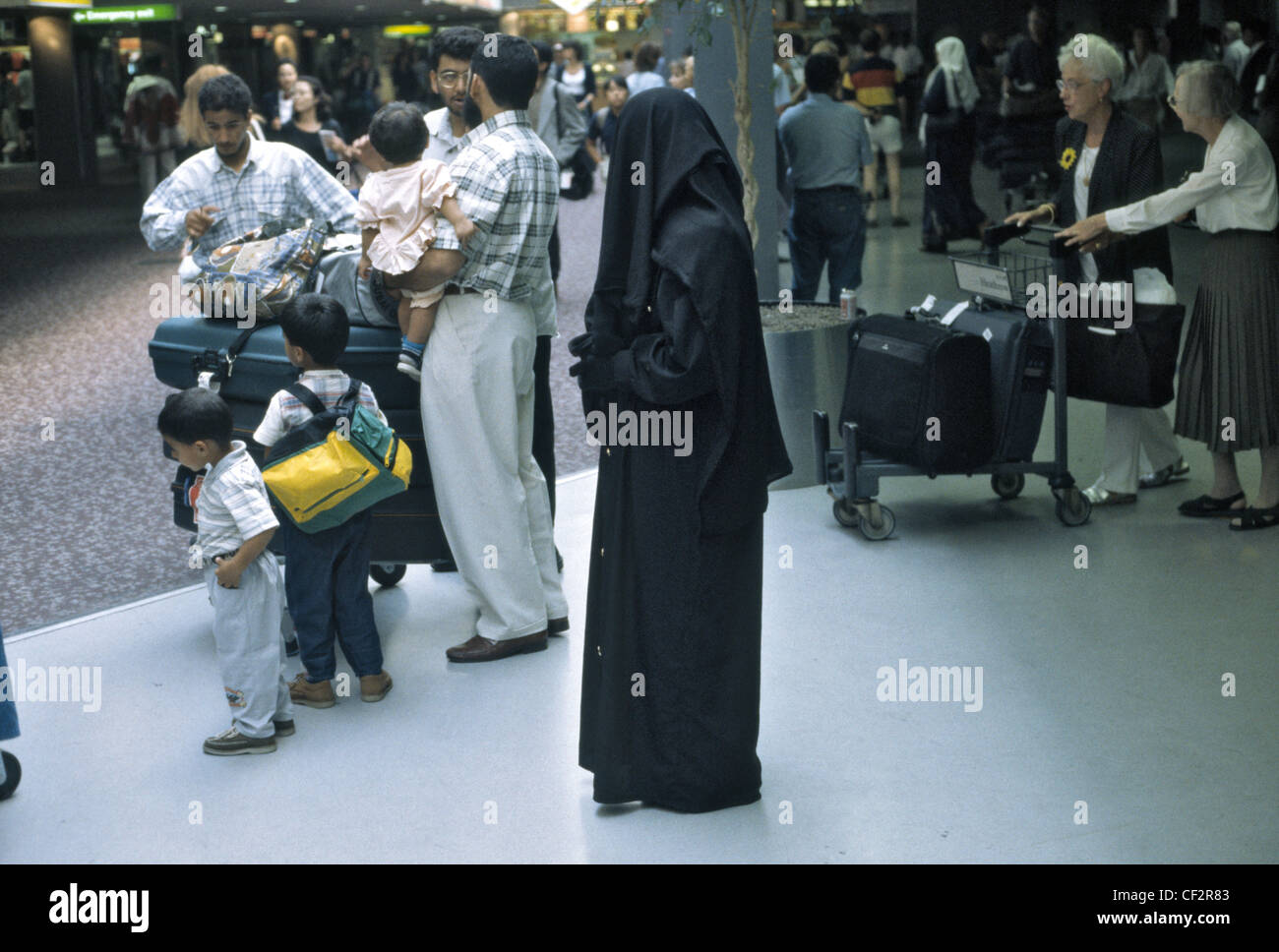 Heavily veiled Muslim woman in Heathrow airport with family and husband ...