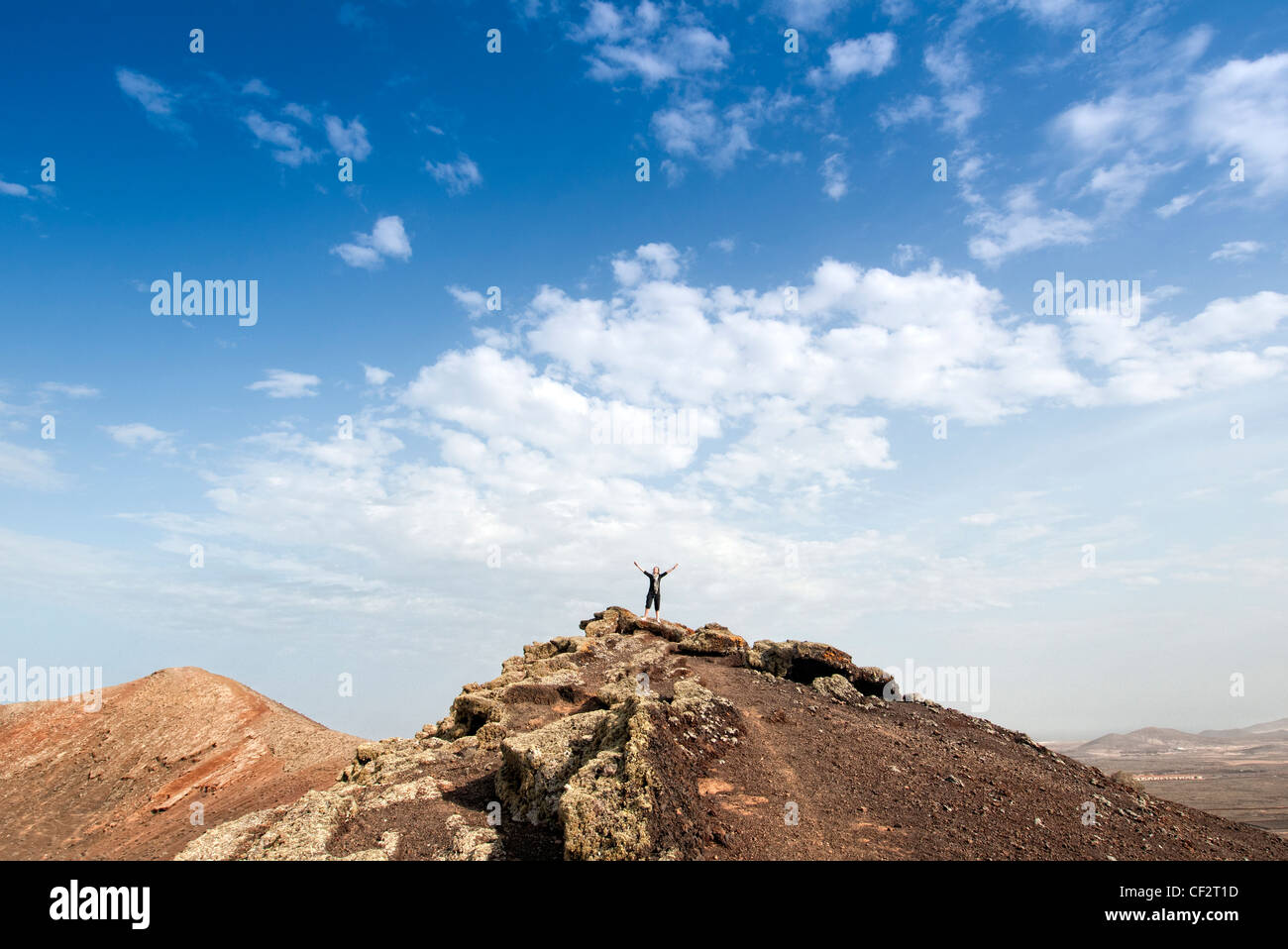 woman standing on top of a volcano Fuerteventura Canary Islands Stock Photo