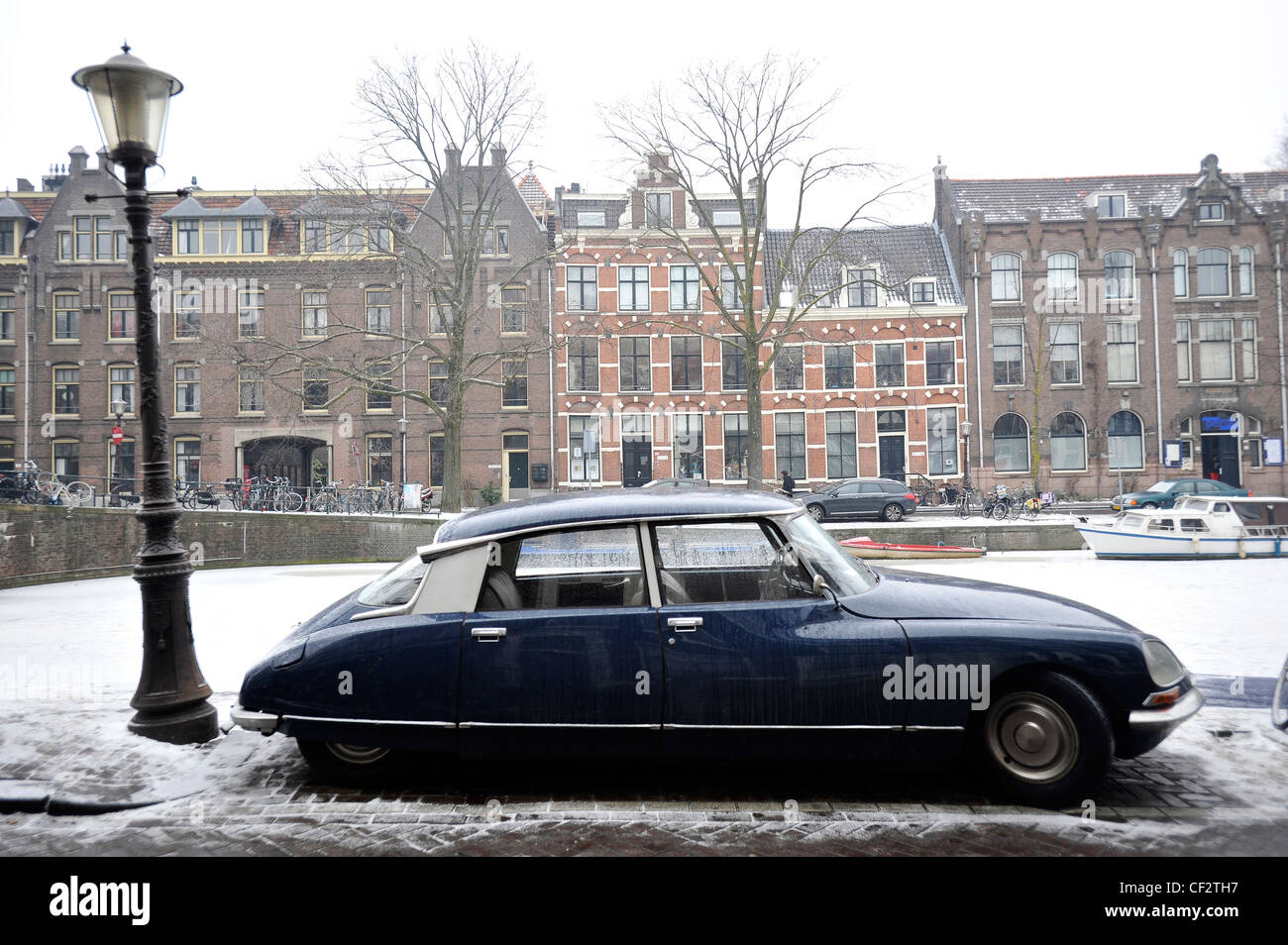 A Citroen DS car parked alongside a frozen canal in Amsterdam, Netherlands. Stock Photo