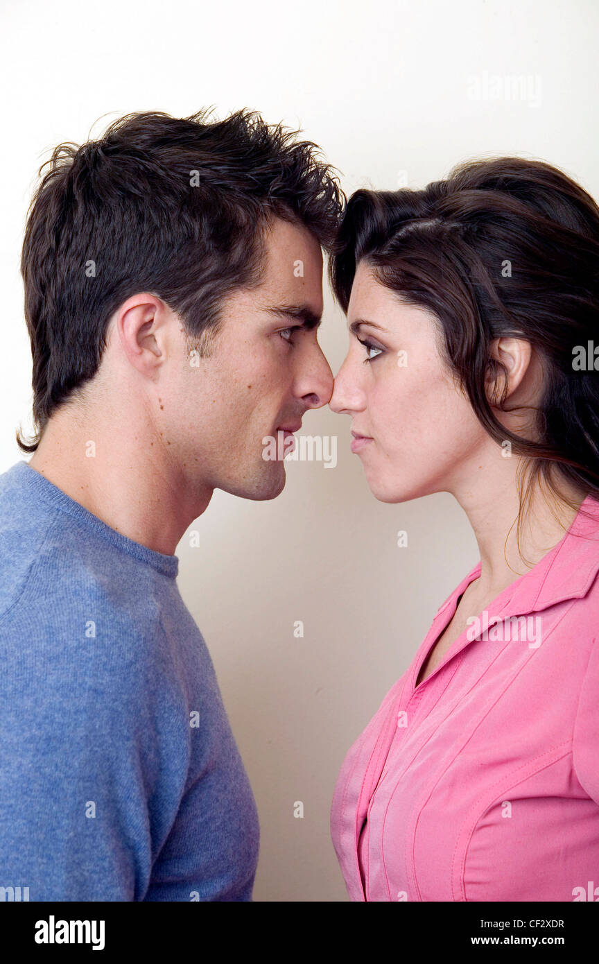 Profile of couple standing nose to nose, male on left short