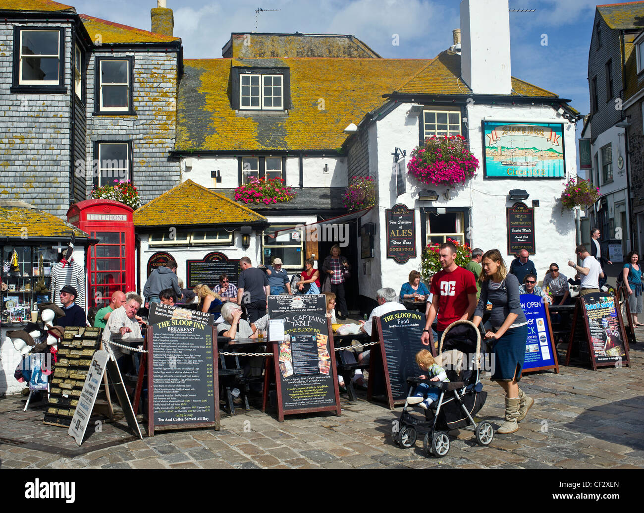 Holidaymakers outside the Sloop Inn in St Ives. Stock Photo