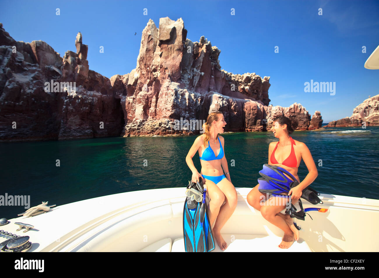 Two Tourists On Boat Edge With Snorkeling Gear At Los Islotes Ntl