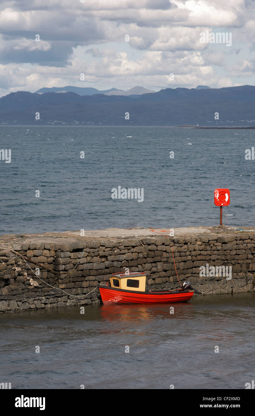 A small red boat in the harbour at Broadford on the Isle of Skye. Stock Photo