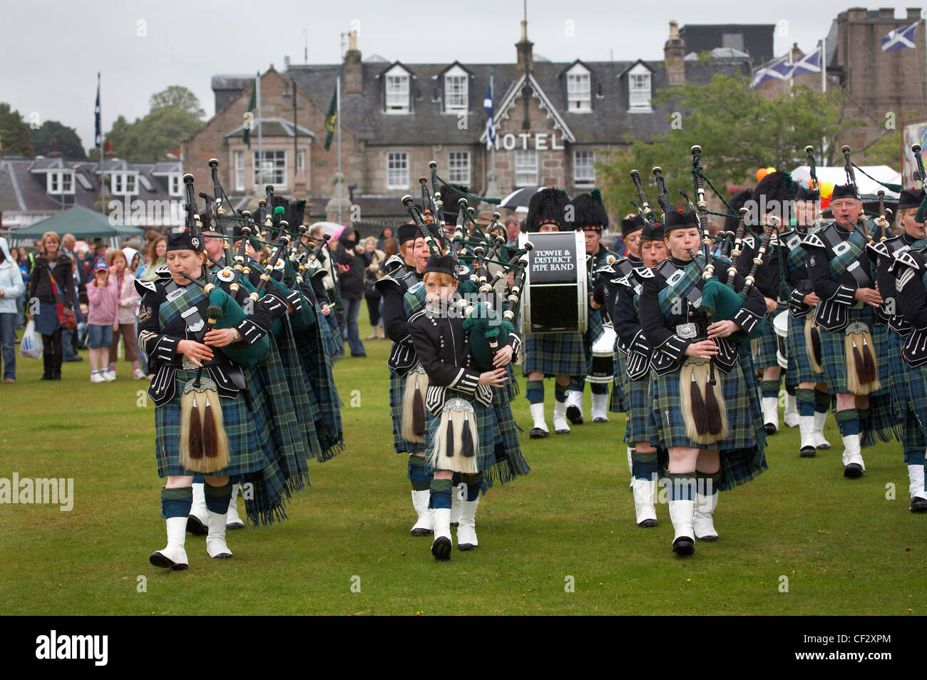 The Towie and District Pipe Band marching at the Lonach Gathering and Highland Games, (billed as ‚Äö√Ñ√≤Scotland's friendliest H Stock Photo