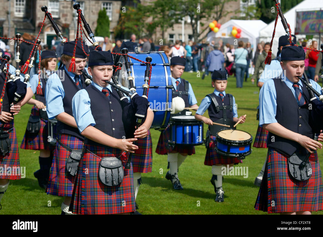 A youth pipe band marching at the Lonach Gathering and Highland Games
