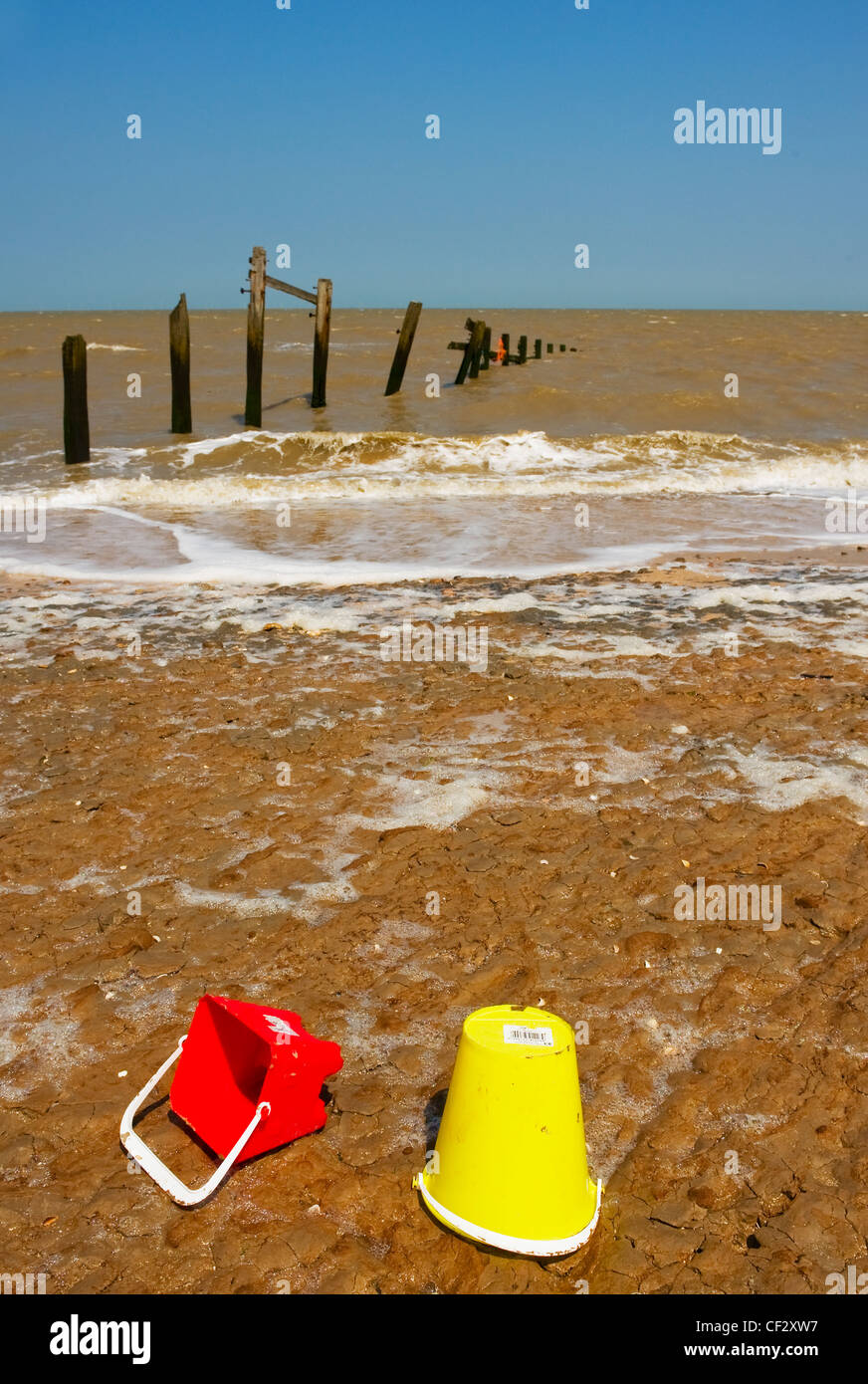 Plastic buckets on Leysdown Beach on the Isle of Sheppey. Stock Photo