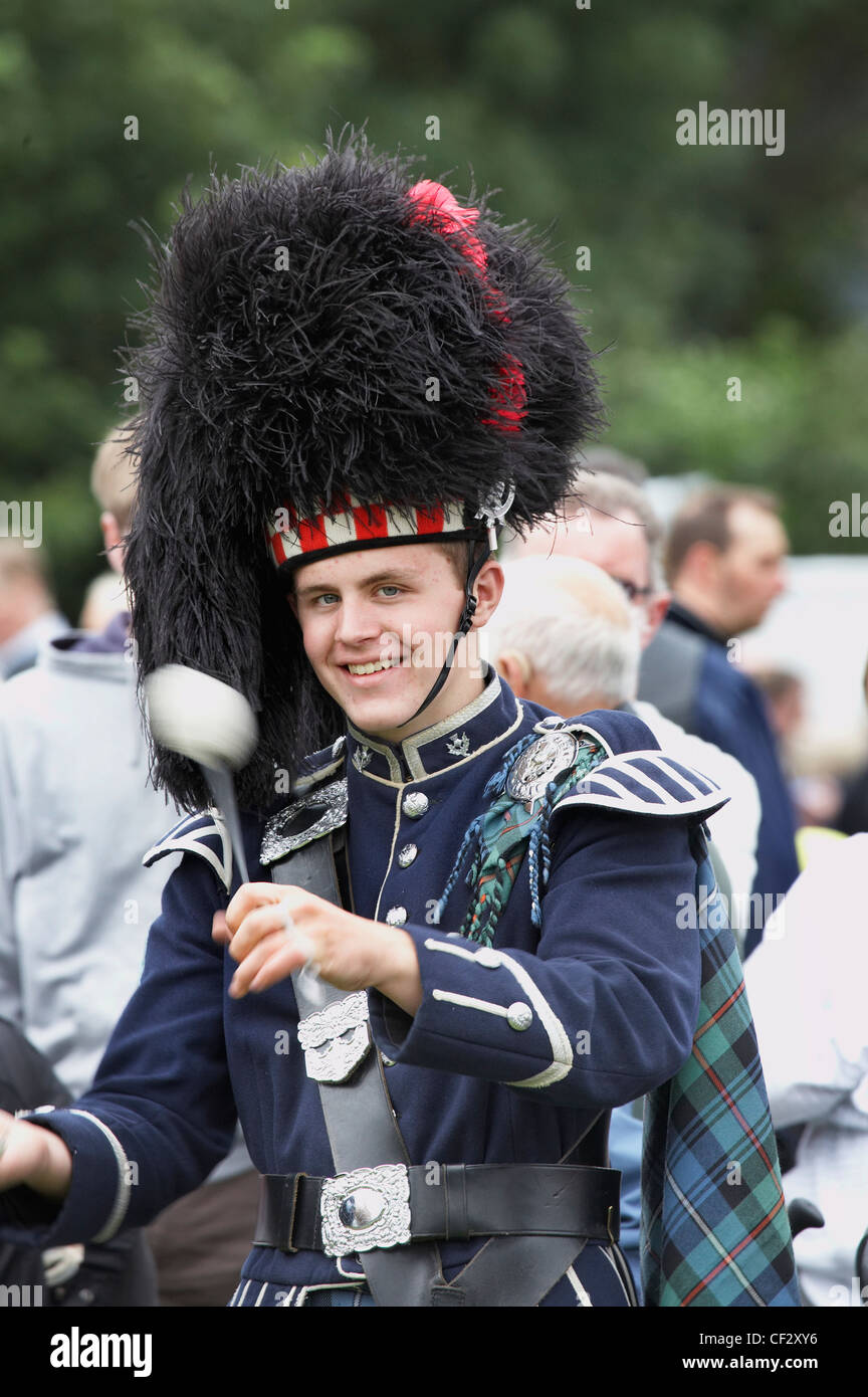 A drummer from a pipe band marching at the Lonach Gathering and Highland Games, (billed as ‚Äö√Ñ√≤Scotland's friendliest Highlan Stock Photo