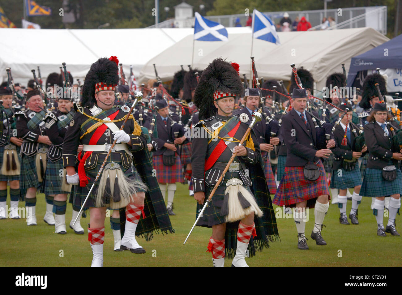Marching pipe bands performing at the Lonach Gathering and Highland Games, (billed as ‚Äö√Ñ√≤Scotland's friendliest Highland Gam Stock Photo