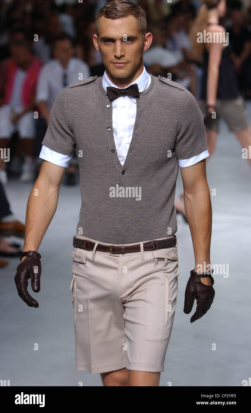 Neil Barrett Milan Menswear S S Grey tight sweater worn over white short  sleeved shirt, beige shorts and black leather gloves Stock Photo - Alamy