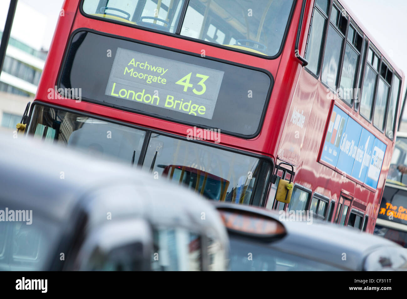 A view of London taxis and a red bus queuing on London Bridge Stock Photo