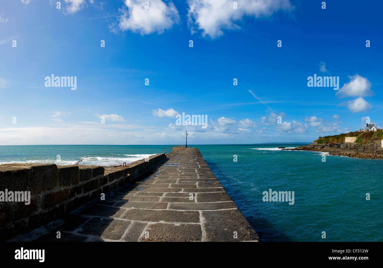 A panoramic view along the harbour wall out to sea at the entrance to Porthleven Harbour. Stock Photo