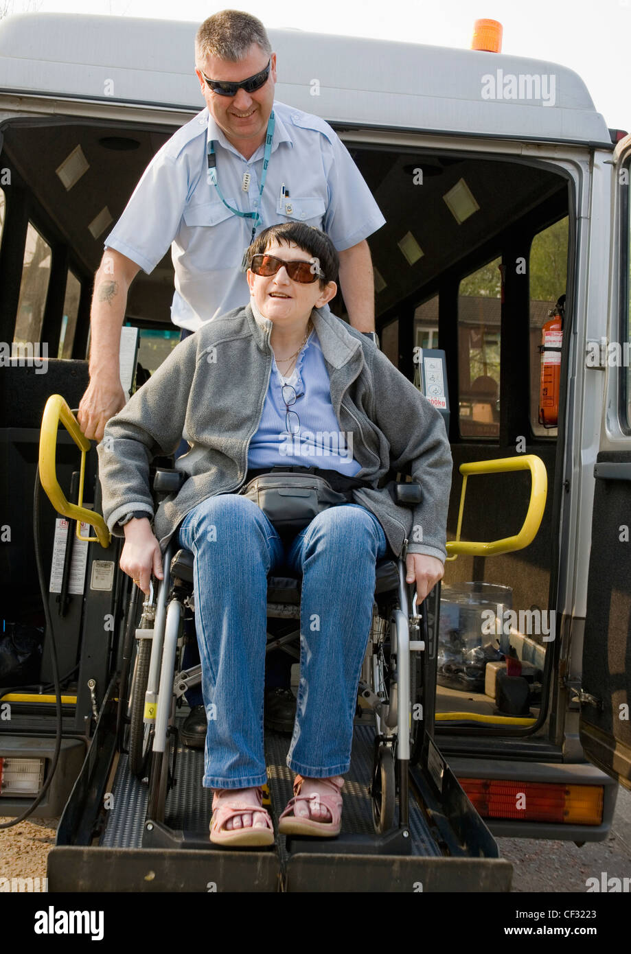 Two Friends Getting Off The Bus With A Wheelchair; Bolton, Lancashire