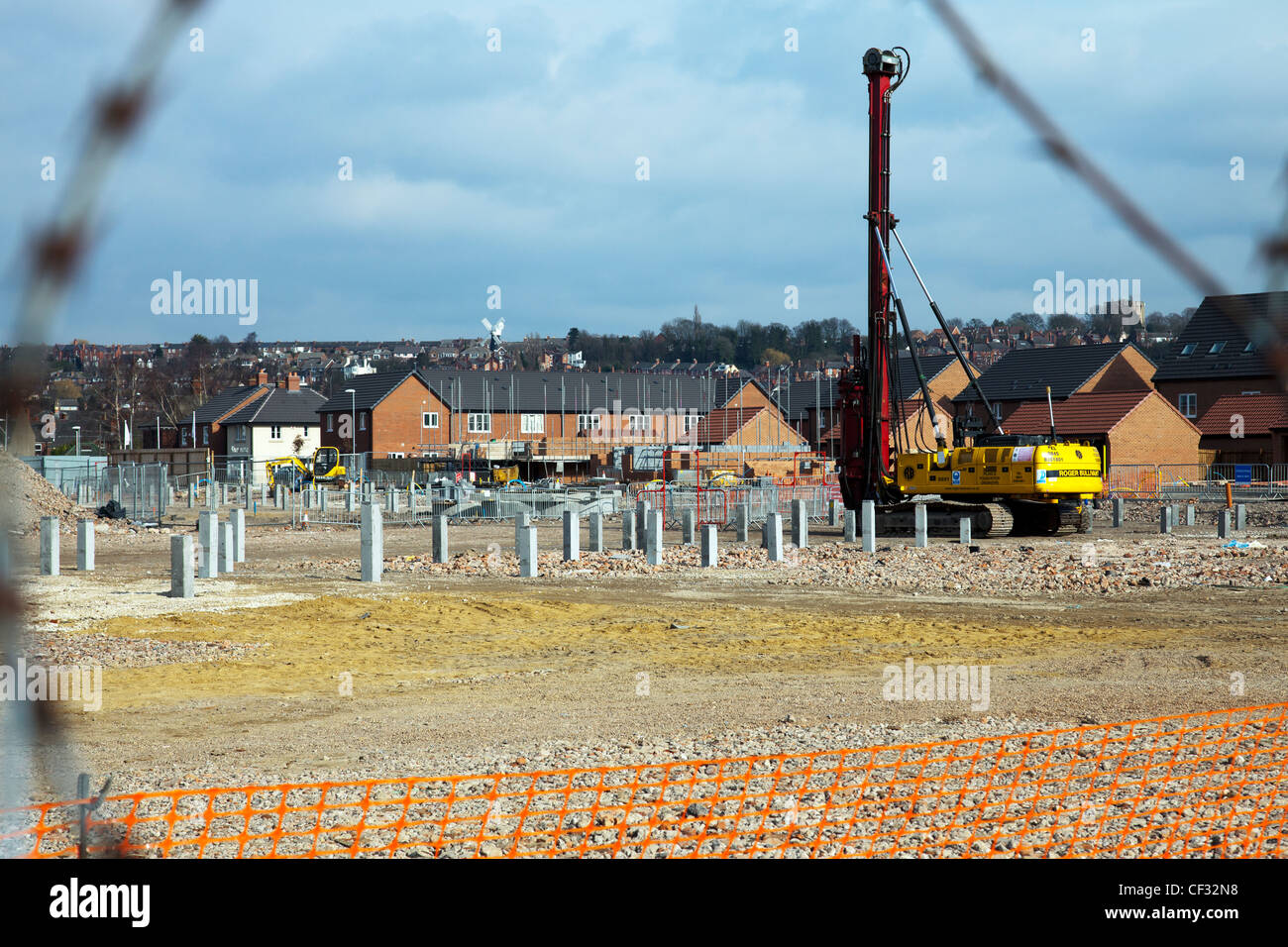 Pile driver on construction site with concrete pillars for stability Stock Photo
