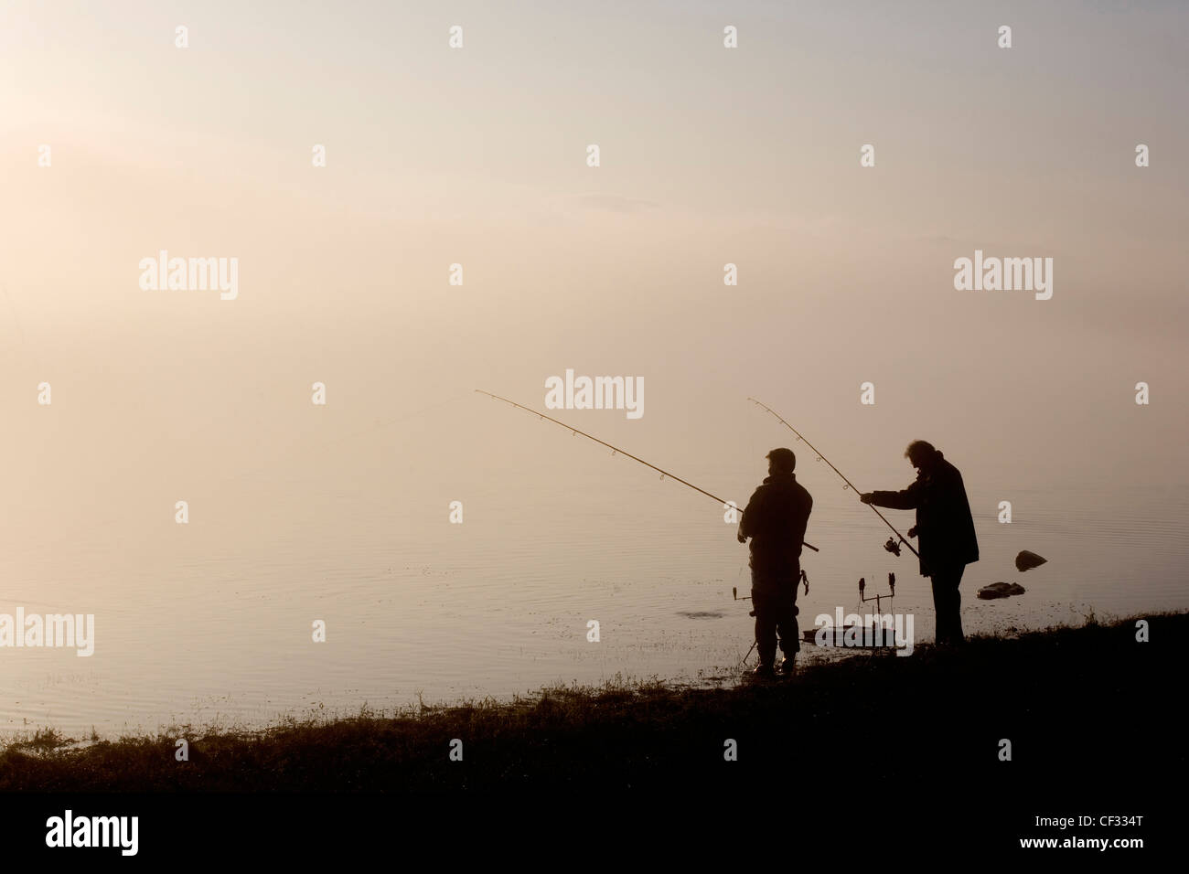 Two silhouettes men in fishing hi-res stock photography and images - Alamy