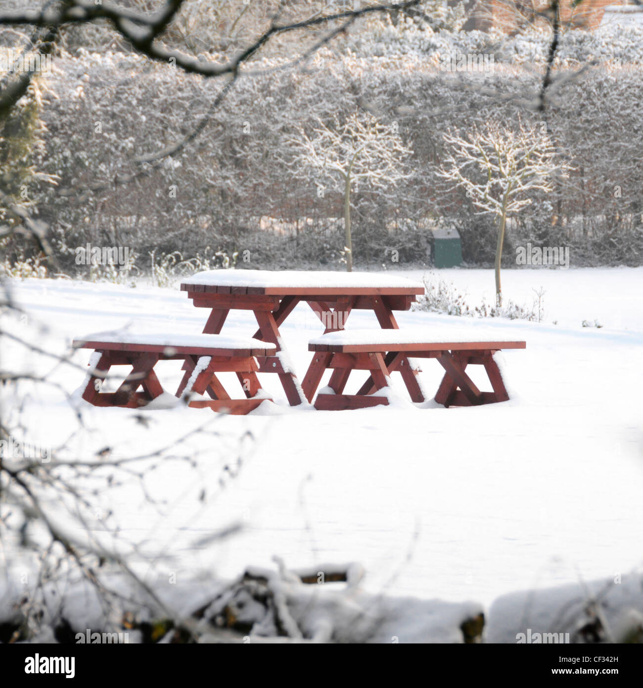Winter Snow scene picnic table and seats in house back garden covered in the white stuff Brentwood Essex England UK Stock Photo