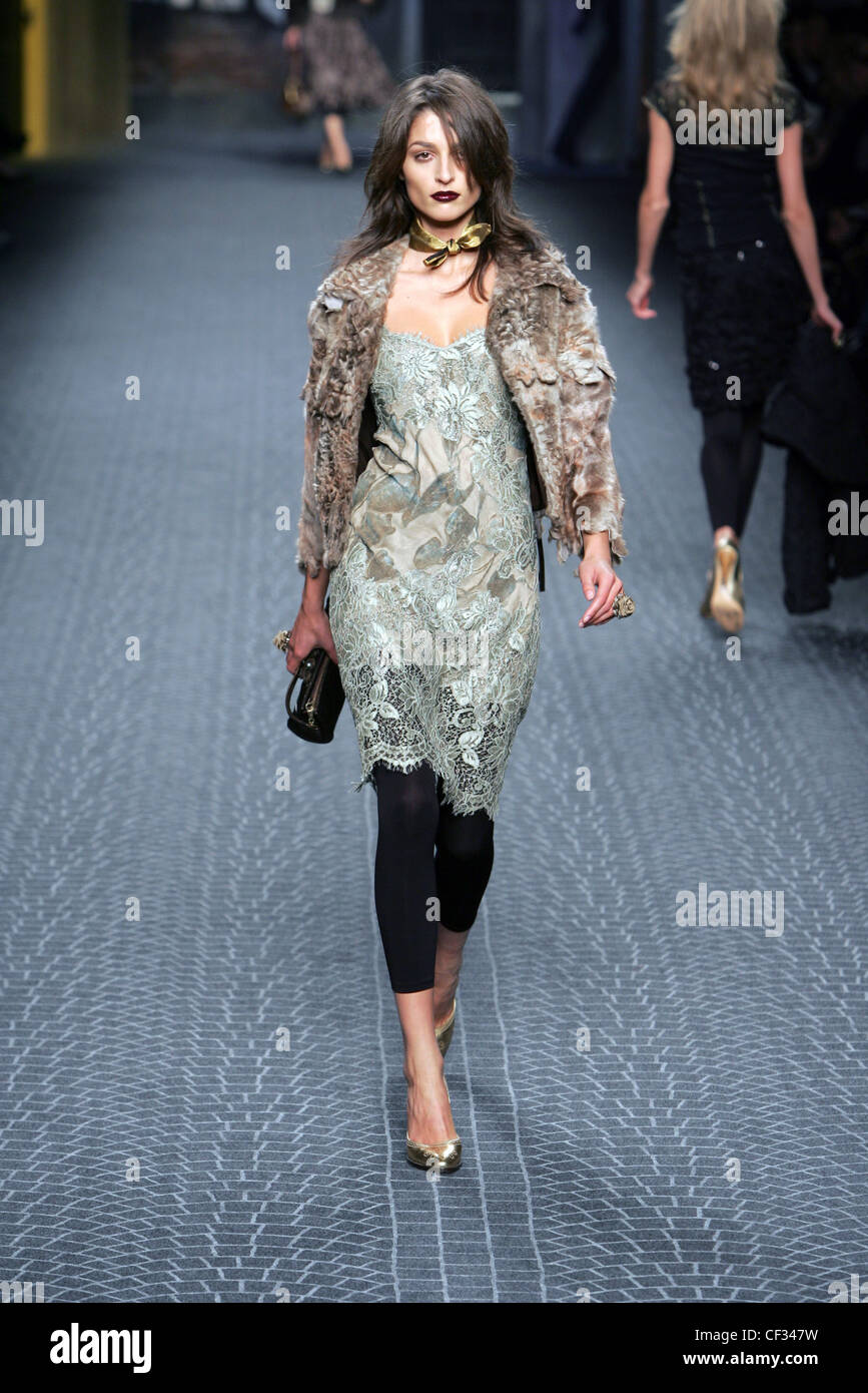 Fluffy fur jacket over pale blue lace knee length dress and footless tights,  gold shoes Stock Photo - Alamy