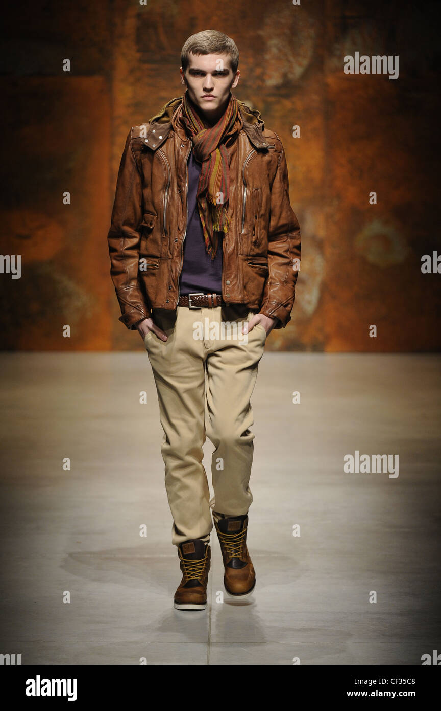 CP Company Milan Ready to Wear Menswear Autumn Winter Beige straight legged  trousers a brown leather braided belt, a purple Stock Photo - Alamy