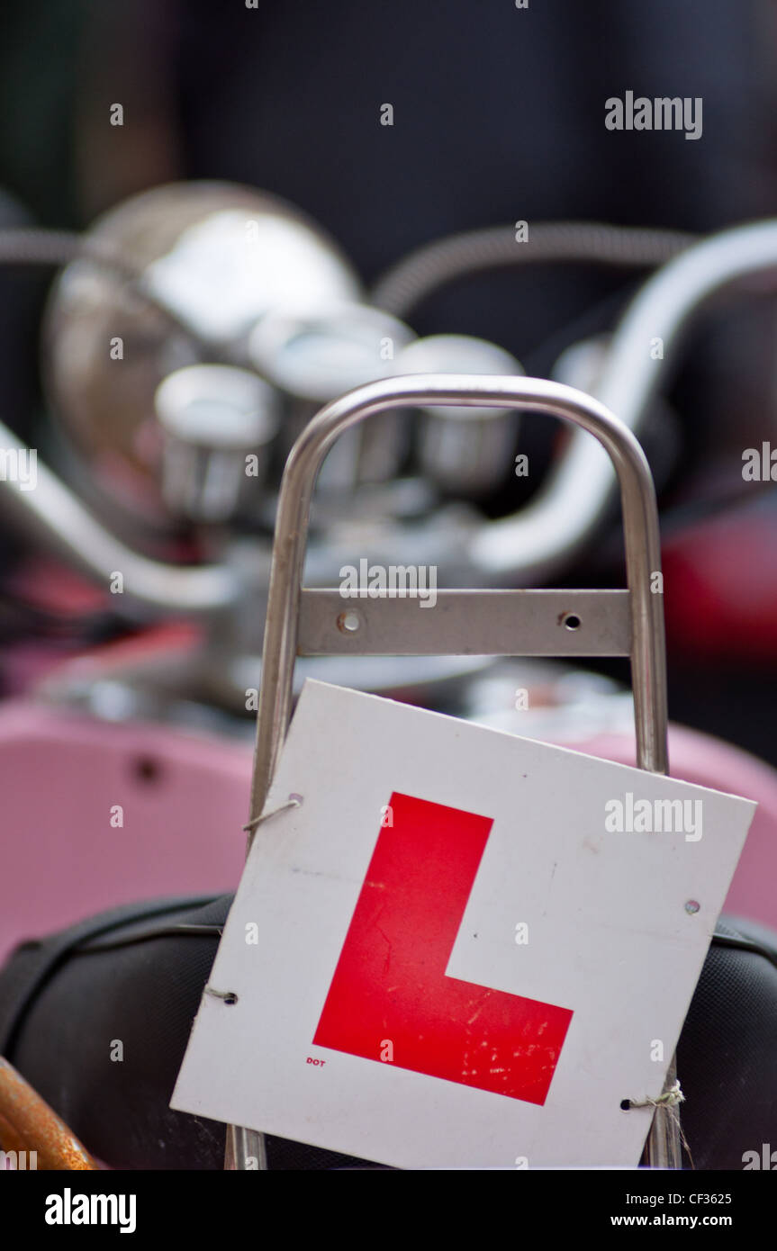 An 'L' plate at the back of a pink scooter. England. Stock Photo