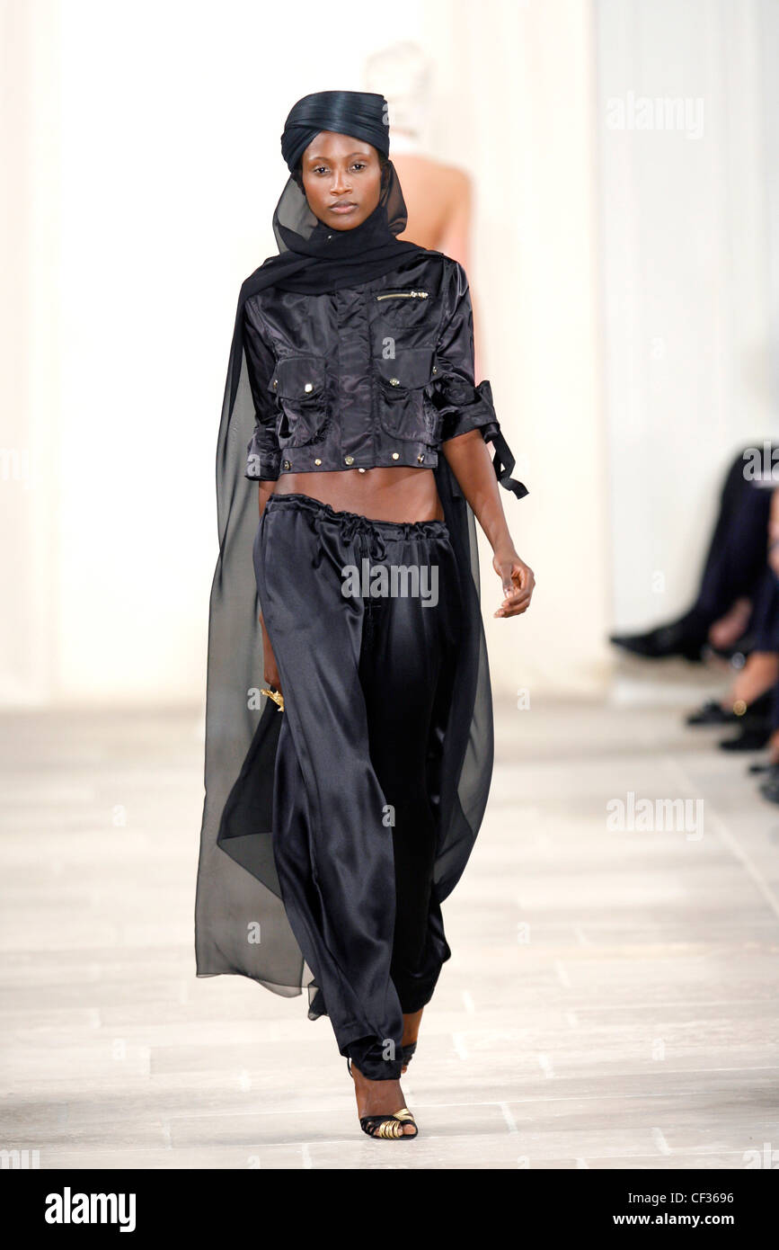 Ralph Lauren New York Ready to Wear Spring Summer Model wearing charcoal  satin harem pants, cropped satin charcoal jacket Stock Photo - Alamy