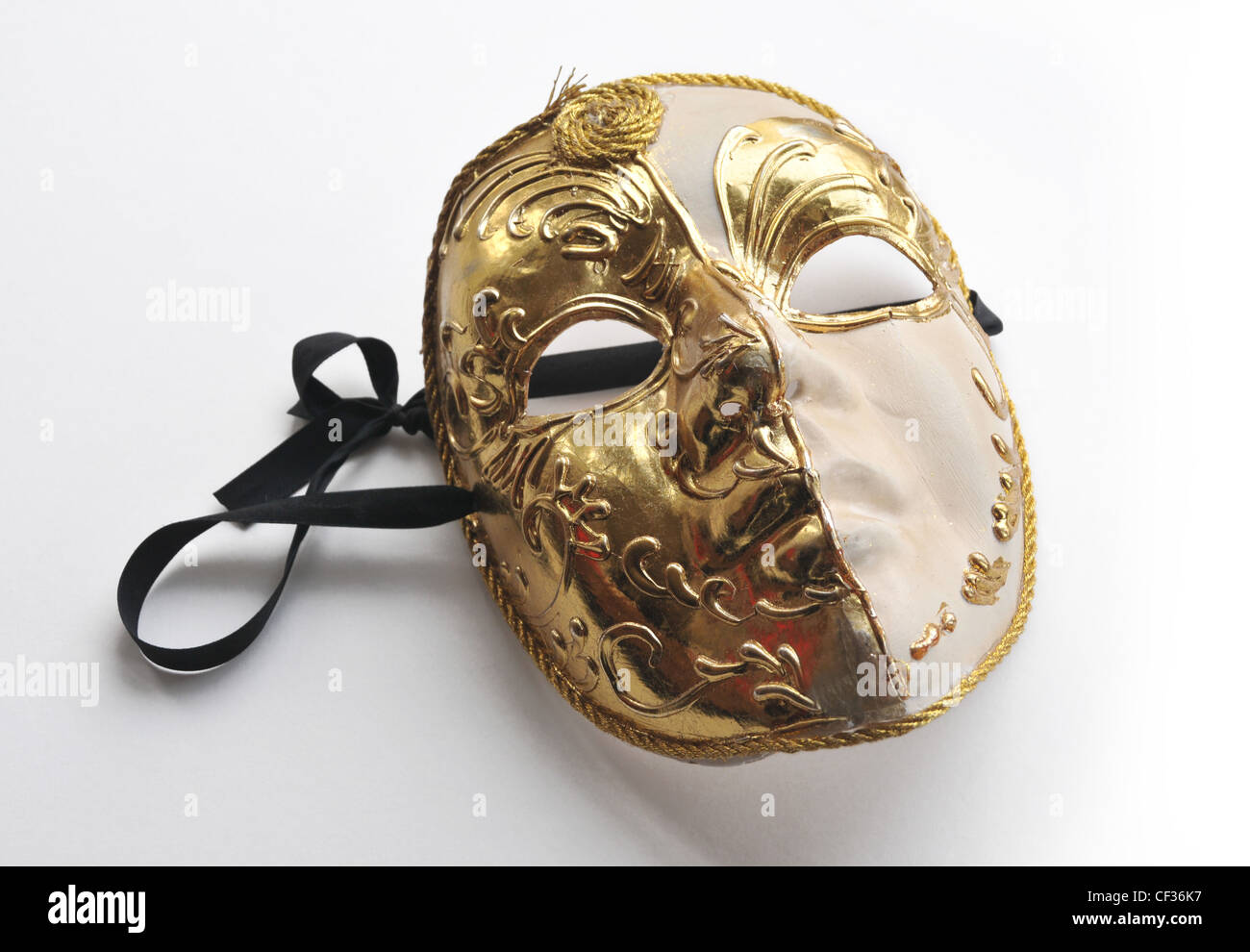 A gold coloured / colored theatrical mask . Stock Photo