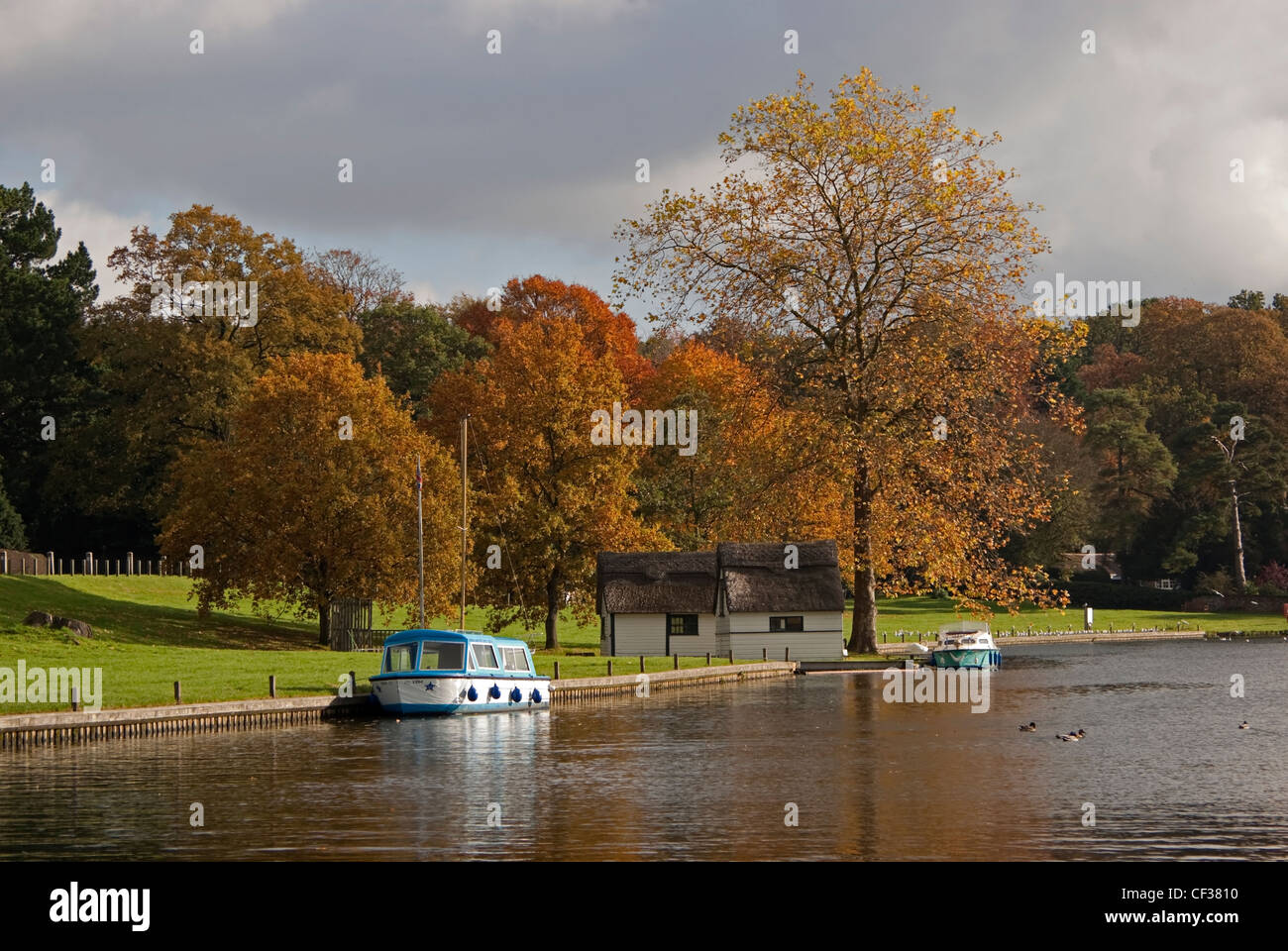 Boats moored on the River Bure at Coltishall in the Norfolk Broads in autumn. Stock Photo