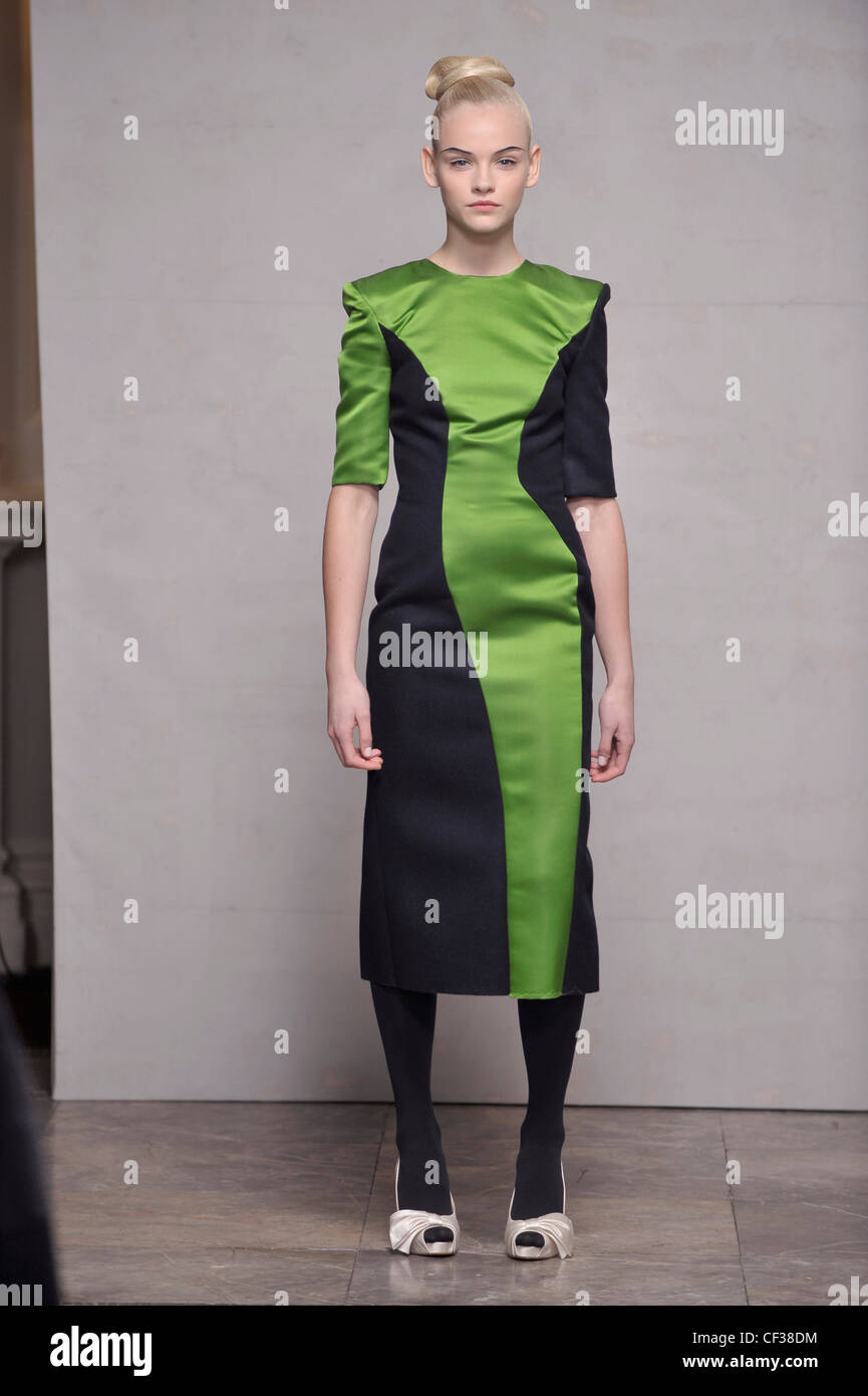 Roksanda Ilincic London Ready to Wear Autumn Winter Tight updo hair, two  tone navy blue and green paneled midi dress, black Stock Photo - Alamy
