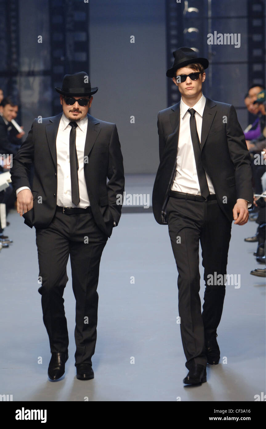 Moschino Menswear Milan A W Blues Brothers motif: two males dressed up like  the Jake and Elwood characters from the movie Stock Photo - Alamy