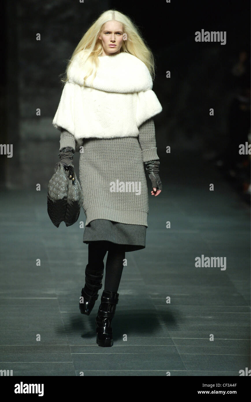 Louis Vuitton Model Romina Lanaro very long blonde hair wearing white fur  cape over grey knitted jumper dress over grey wool Stock Photo - Alamy