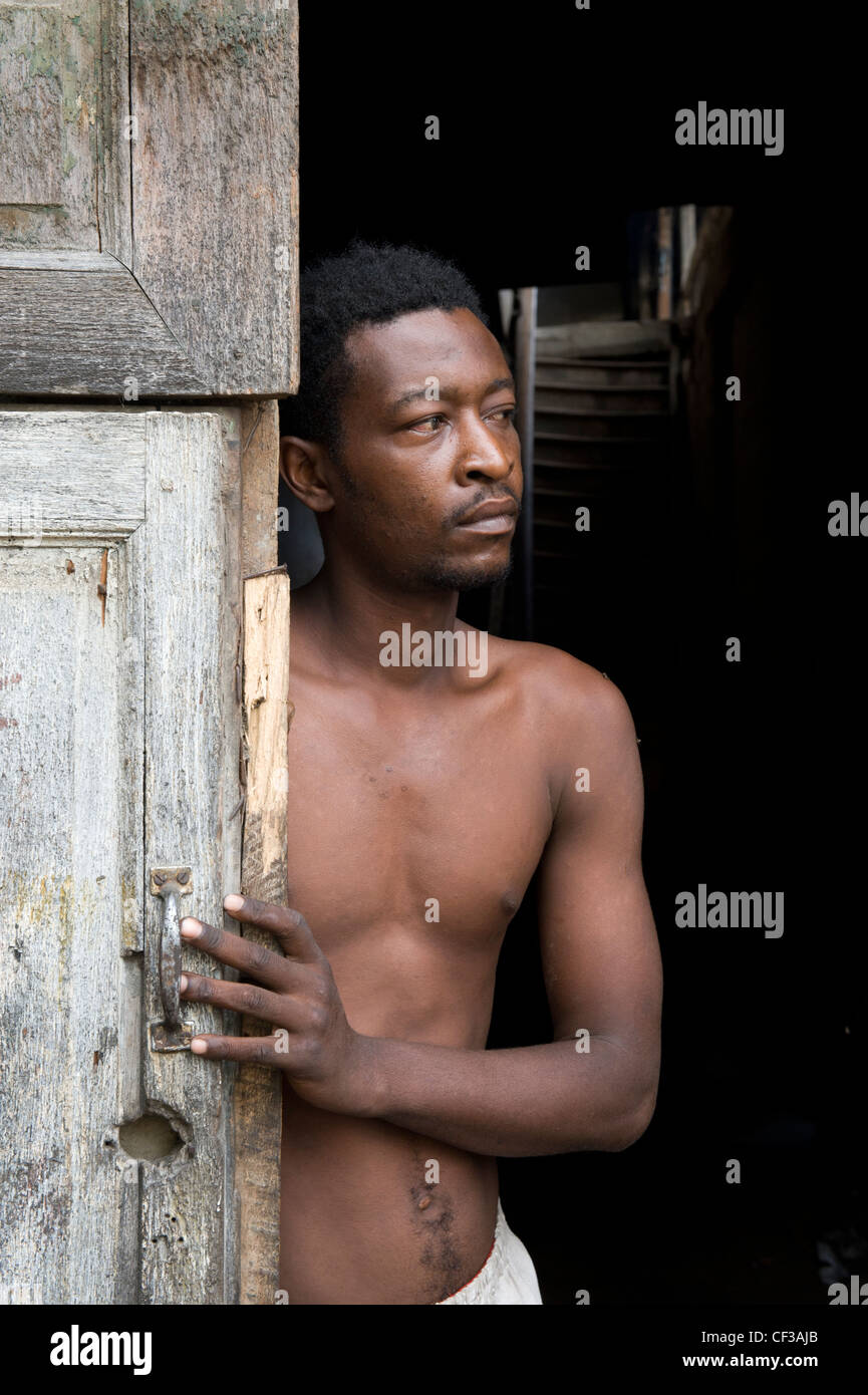 Man standing in an entrance door Stone Town Zanzibar Tanzania Stock Photo