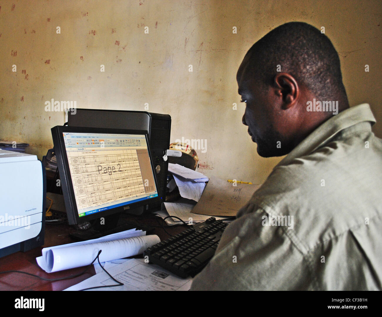 Staff use computers in a local government office in Kenema, Sierra Leone Stock Photo