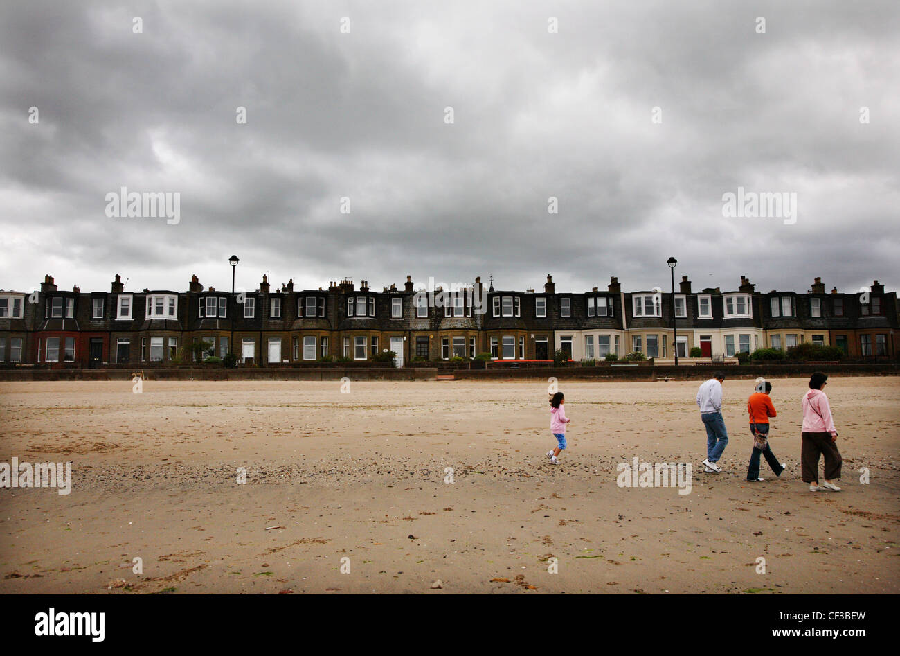 A grey sky over people walking on Portobello beach in Edinburgh. Stock Photo