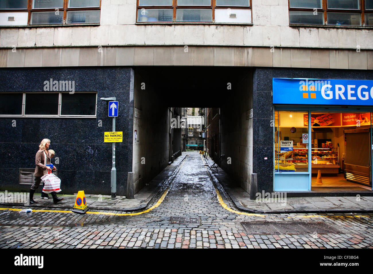 Two people walking with shopping bags on West Register Street in