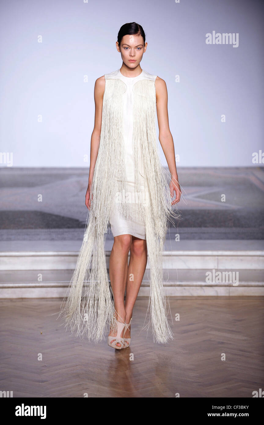 Off white sleeveless dress with floor length tassels Stock Photo