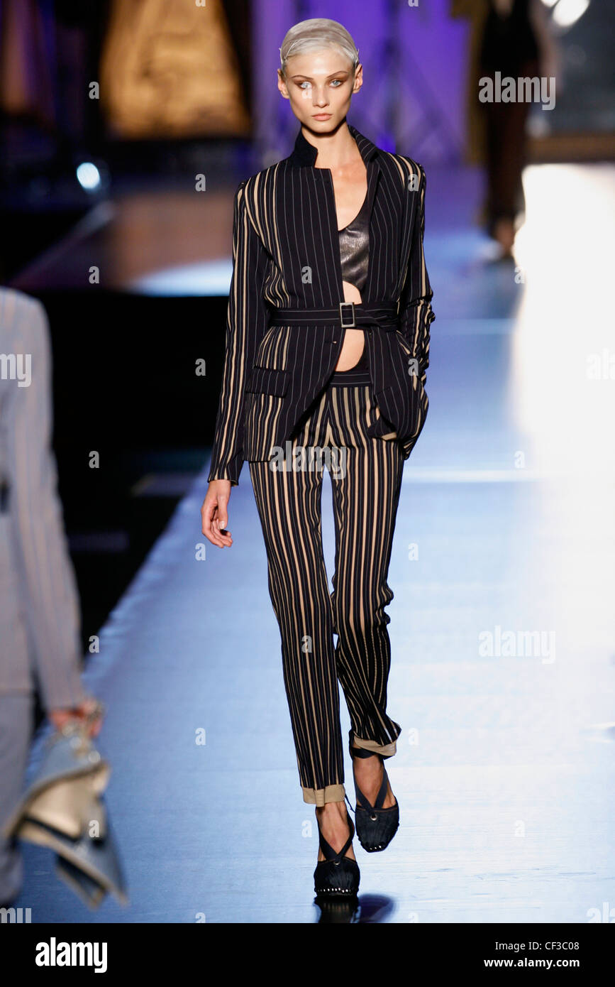 Jean Paul Gaultier Paris Ready to Wear Spring Summer Model wearing black  and beige striped tight trousers, matching jacket Stock Photo - Alamy