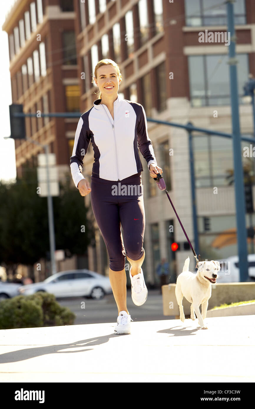 Female Blonde Hair Tied Into Ponytail Wearing A White And Purple