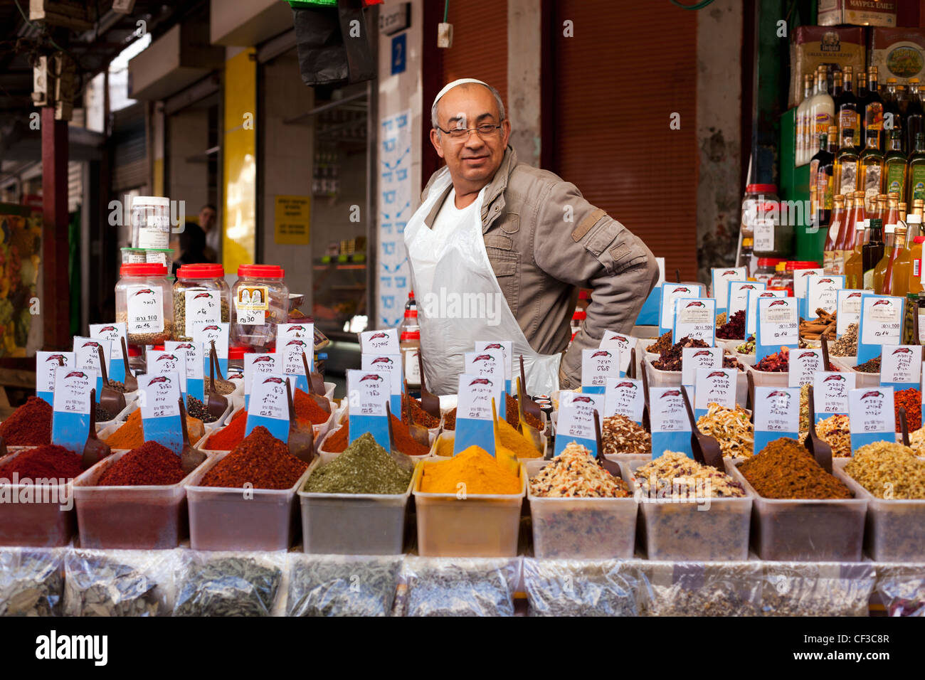 Israel, Tel Aviv,Carmel Market, spice vendor with samples of fresh spices Stock Photo