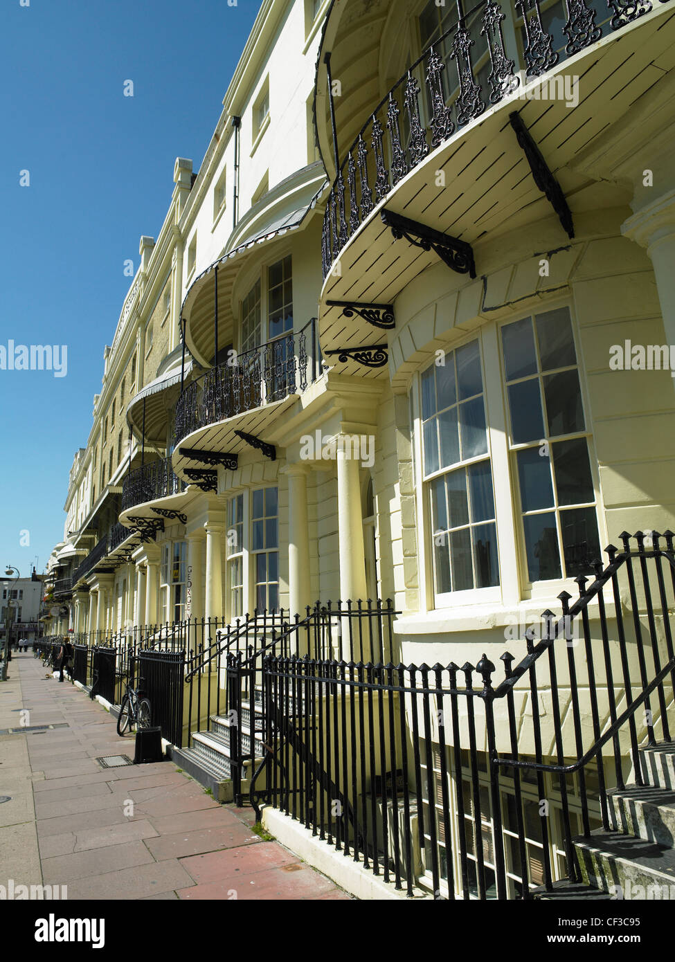 A view along a row of Regency houses with balconies on Brighton seafront. Stock Photo