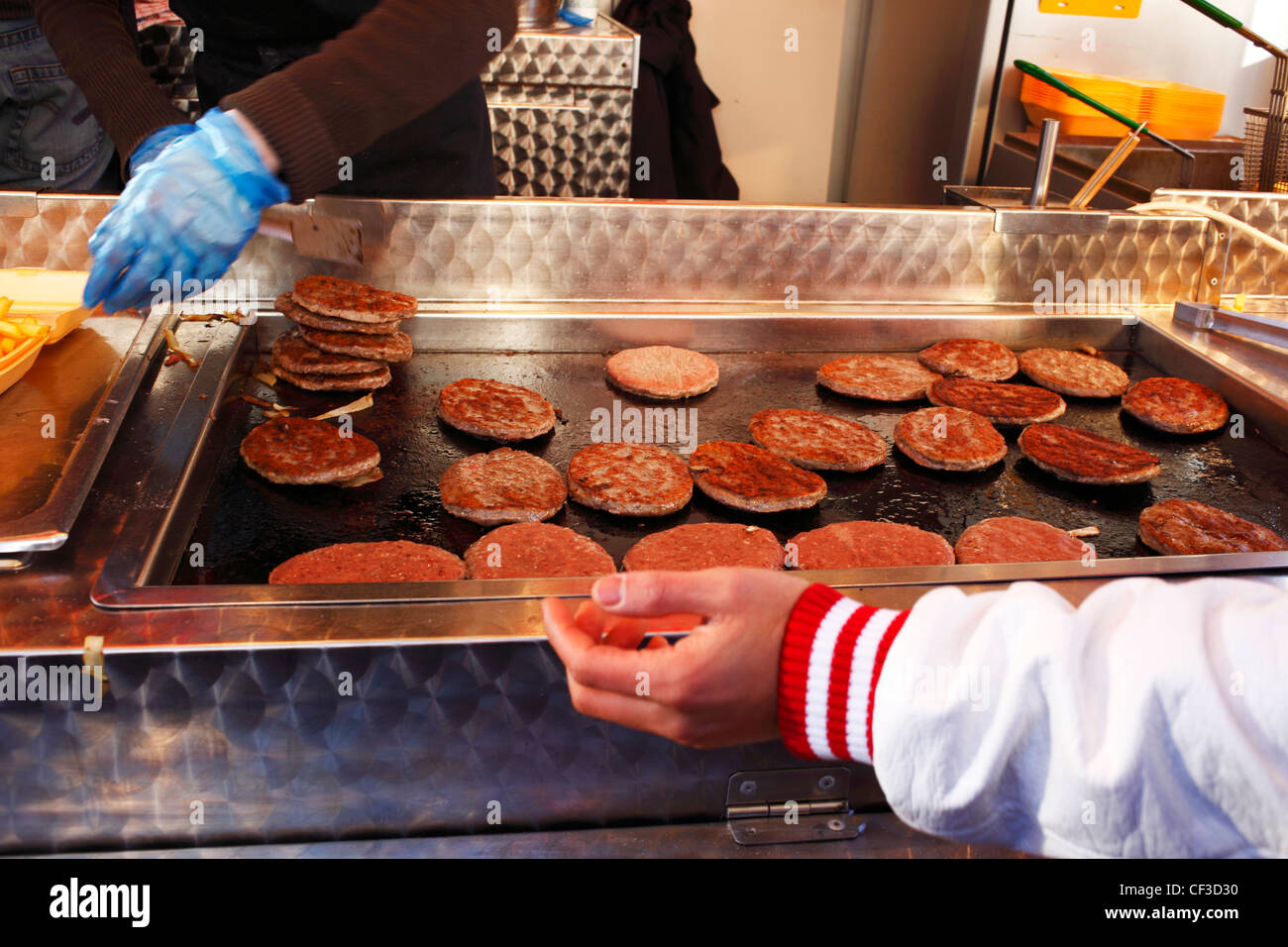 Burgers and fries being prepared in a van on Anfield Road on a match day in Liverpool. Stock Photo
