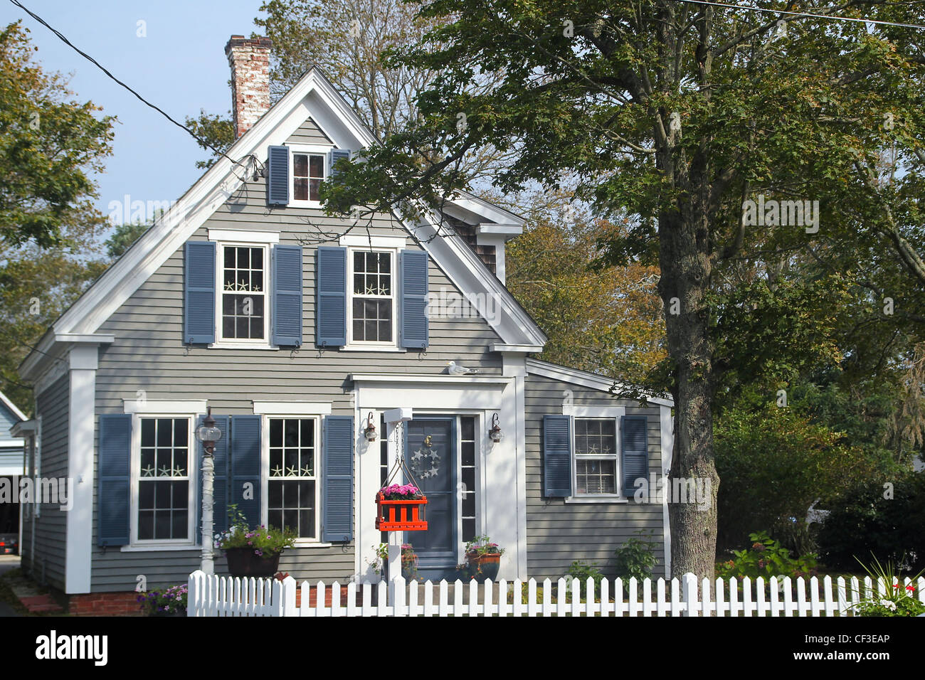 An old house behind a white fence Stock Photo