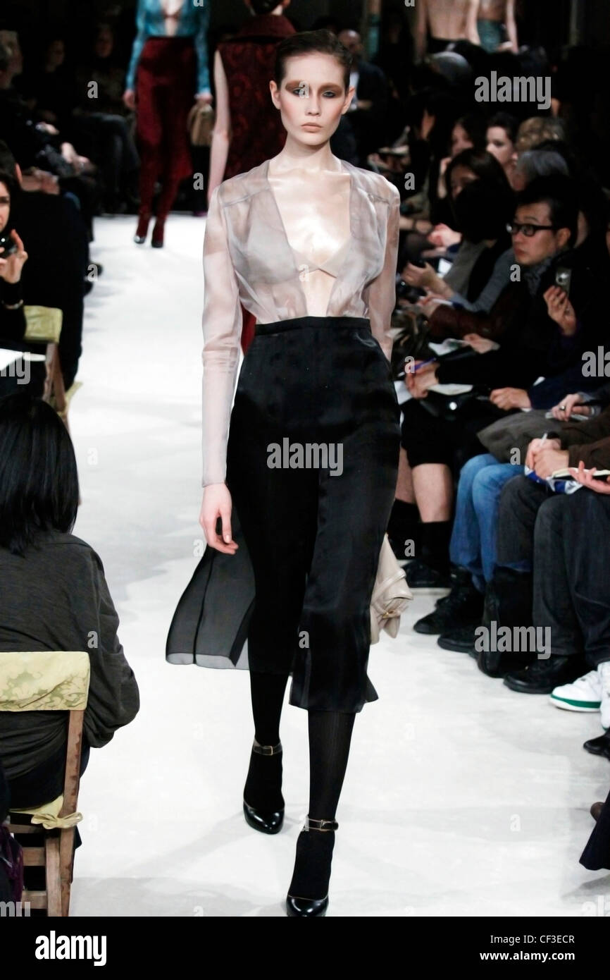 Miu Miu Paris Ready to Wear Autumn Winter Chiffon: Long sleeved sheer  blouse and black knee length skirt Stock Photo - Alamy