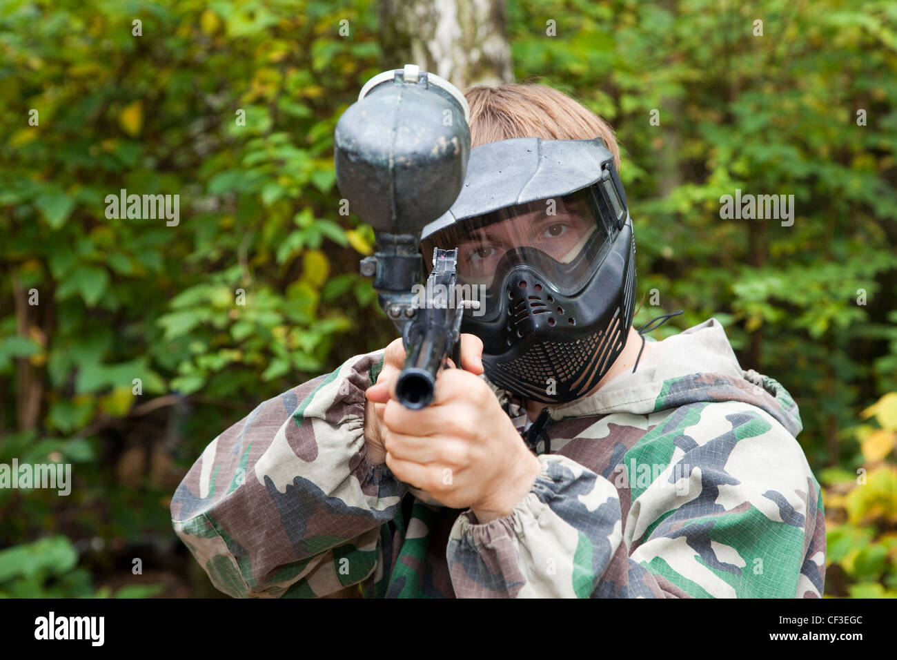 paintball player is aiming, looking in the face Stock Photo