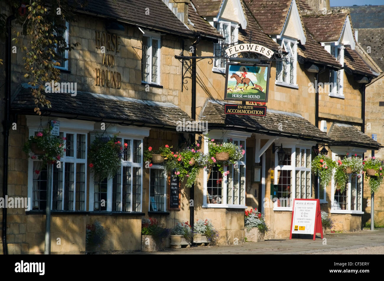 Hanging baskets at the front of a traditional village pub in Broadway. Stock Photo