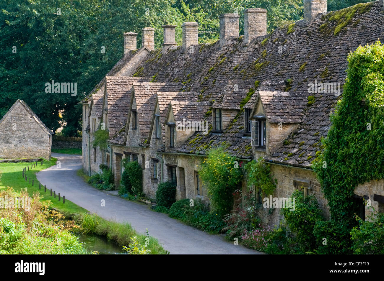 A row of traditional Cotswold cottages in the village of Bibury. Stock Photo