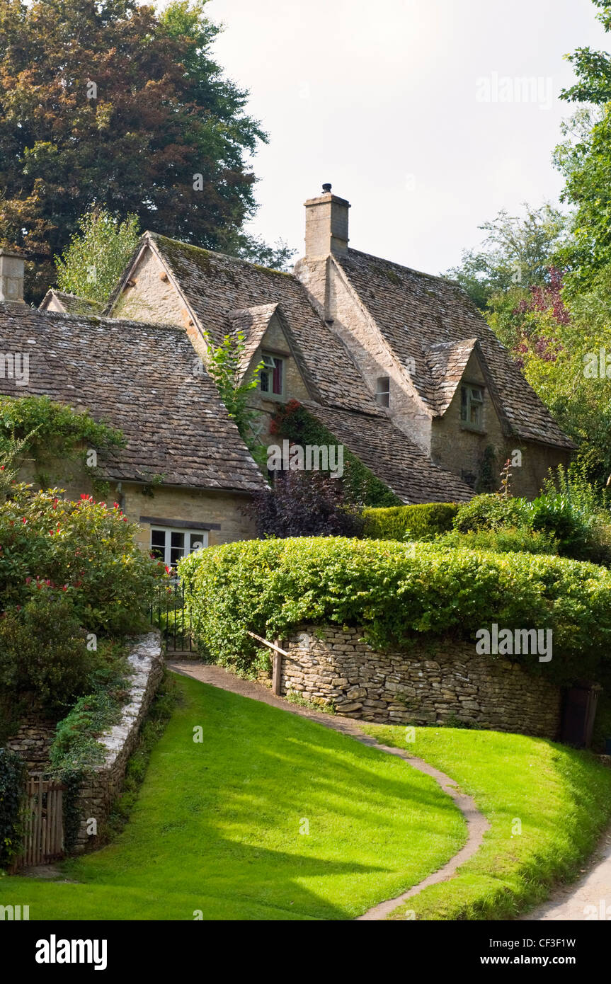 A garden path leading to traditional Cotswold cottages in the village of Bibury. Stock Photo