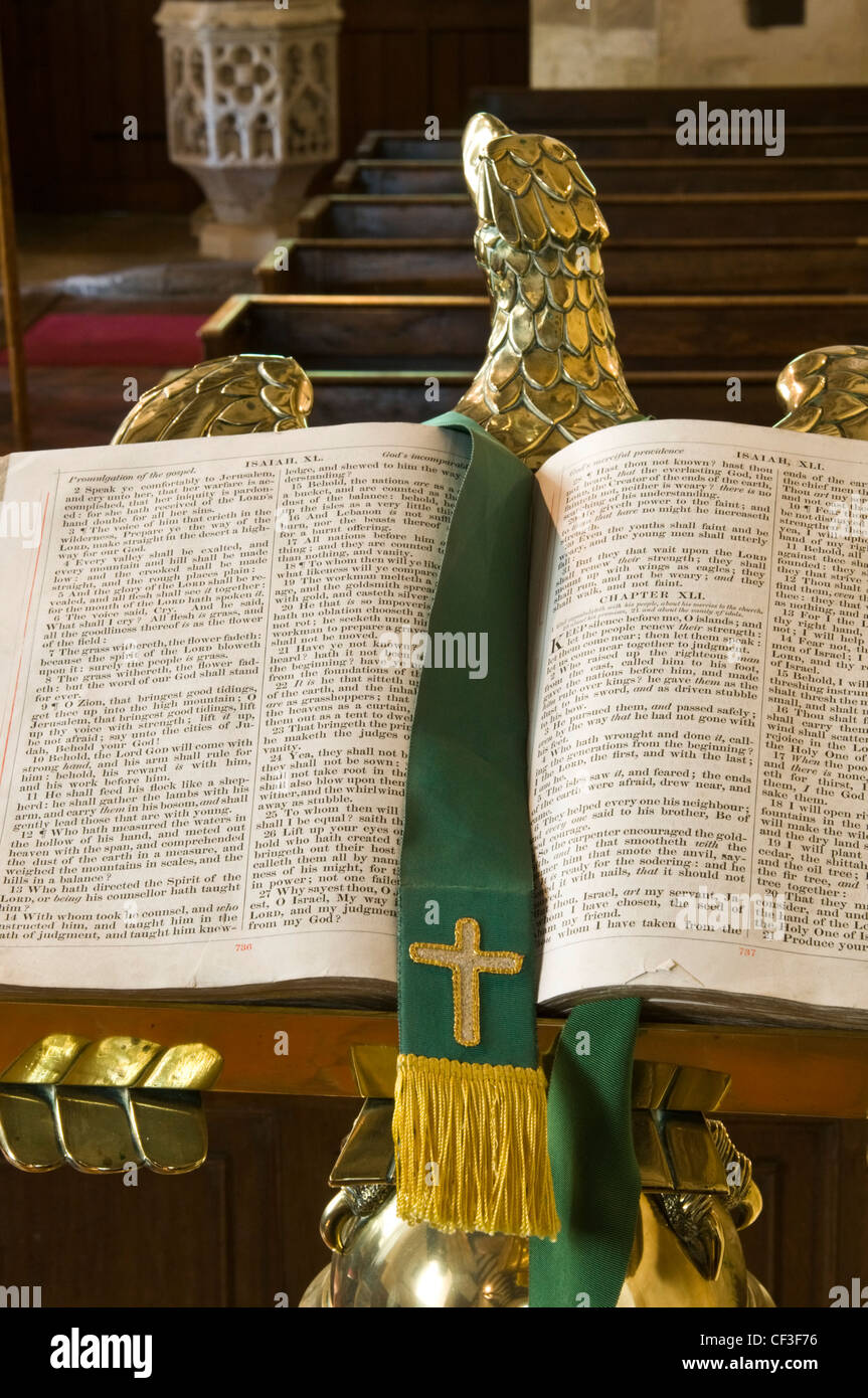 Open bible in front of the pews in St Peter's Church. Stock Photo