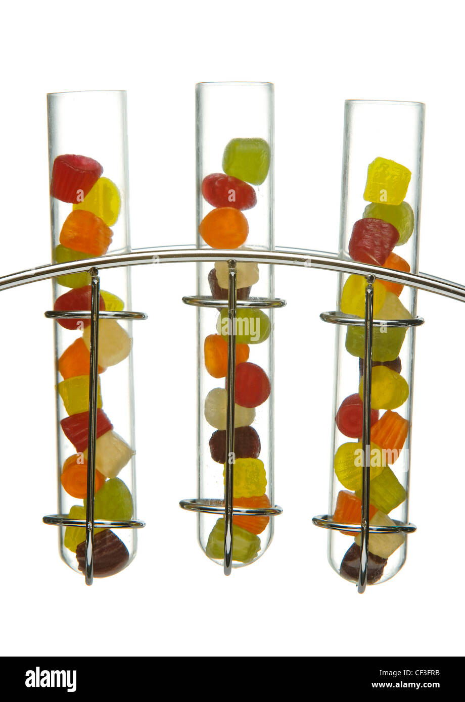 Miniature wine gums in glass test tubes in a chrome stand Stock Photo