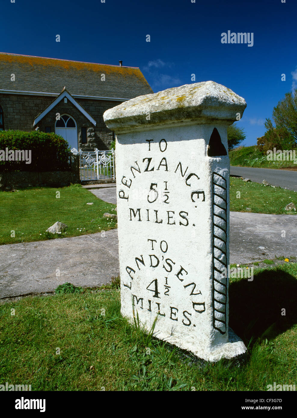 A three-sided milestone and converted chapel at a junction on the A30 road between Penzance and Land's End. Stock Photo